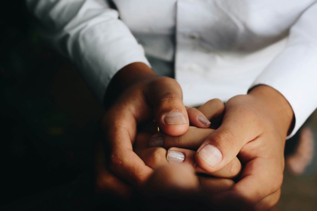 Close-up of hands, offering support and care